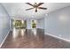 Spacious living room featuring wood floors, ceiling fan, and sliding glass doors at 40 Moree Loop # 11, Winter Springs, FL 32708