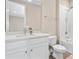 Bright bathroom features a modern vanity with stone countertop, white cabinets and tile at 4418 Lions Gate Ave, Clermont, FL 34711