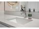 Contemporary bathroom vanity with quartz countertop, chrome faucet, and decorative mirror at 4418 Lions Gate Ave, Clermont, FL 34711