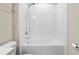Bathroom featuring a sleek shower and bathtub combination with white tile and modern fixtures at 4418 Lions Gate Ave, Clermont, FL 34711