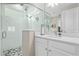 Modern bathroom featuring a glass-enclosed shower, hexagon tile floor, and a white vanity with a quartz countertop at 4418 Lions Gate Ave, Clermont, FL 34711