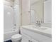 Cozy bathroom featuring a bathtub with shower, a white vanity with a quartz countertop, and modern fixtures at 4418 Lions Gate Ave, Clermont, FL 34711