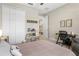 Neutral bedroom features a workspace, plush carpeting, and a decorative shelf displaying Star Wars memorabilia at 4418 Lions Gate Ave, Clermont, FL 34711