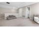 Spacious bonus room featuring plush carpet, neutral walls, and a half wall overlooking the downstairs area at 4418 Lions Gate Ave, Clermont, FL 34711