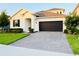 Charming single-Gathering home featuring a paved driveway, a two-car garage, and well-maintained landscaping at 4418 Lions Gate Ave, Clermont, FL 34711