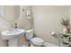 Powder room showing a pedestal sink with a modern faucet and neutral walls at 4418 Lions Gate Ave, Clermont, FL 34711