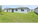 Green backyard offering ample lawn space and fresh exterior paint; ideal for outdoor entertaining at 4544 Windy Oak Way, St Cloud, FL 34772