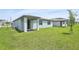 A well-maintained backyard features lush green grass and a covered patio area, perfect for outdoor relaxation at 4544 Windy Oak Way, St Cloud, FL 34772