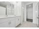 Bright bathroom with dual vanities, white cabinets, and a walk-in shower at 4544 Windy Oak Way, St Cloud, FL 34772