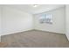 A carpeted bedroom with a bright window at 4544 Windy Oak Way, St Cloud, FL 34772