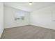 A carpeted bedroom with a bright window at 4544 Windy Oak Way, St Cloud, FL 34772