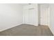 Bright bedroom featuring gray carpet flooring, a closet, and freshly painted white walls at 4544 Windy Oak Way, St Cloud, FL 34772