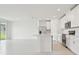 Modern open-concept kitchen featuring white cabinets, stainless steel appliances, and a spacious island with bar seating at 4544 Windy Oak Way, St Cloud, FL 34772