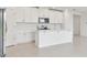 Modern kitchen featuring white cabinets, stainless steel appliances, and a stylish island at 4544 Windy Oak Way, St Cloud, FL 34772