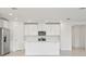 Modern kitchen featuring white cabinets, quartz countertops, and stainless steel appliances at 4544 Windy Oak Way, St Cloud, FL 34772