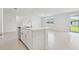 Kitchen island with stainless steel dishwasher, sink, faucet, and white cabinets at 4544 Windy Oak Way, St Cloud, FL 34772
