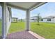 Covered patio offering brick flooring and views of the backyard lawn area, ideal for outdoor relaxation at 4544 Windy Oak Way, St Cloud, FL 34772