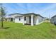 Well-maintained backyard featuring a covered patio, perfect for outdoor dining and entertaining guests at 4550 Windy Oak Way, St Cloud, FL 34772