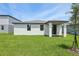 Well-manicured backyard with a covered patio, offering an inviting space for outdoor enjoyment and relaxation at 4550 Windy Oak Way, St Cloud, FL 34772