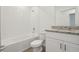Modern bathroom with granite countertops and bathtub with shower at 4550 Windy Oak Way, St Cloud, FL 34772