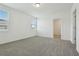Spacious empty bedroom featuring carpet, base trim, two windows, and white walls at 4550 Windy Oak Way, St Cloud, FL 34772