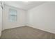 Bright bedroom with neutral walls, plush carpet, and a window at 4550 Windy Oak Way, St Cloud, FL 34772