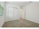 Bedroom featuring window, closet, neutral walls and carpet with additional door to hall at 4550 Windy Oak Way, St Cloud, FL 34772