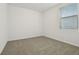 Sunlit bedroom features a window, neutral walls, and soft, cozy carpet at 4550 Windy Oak Way, St Cloud, FL 34772