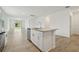 Kitchen with stainless steel dishwasher and sink in island, opens to dining area at 4550 Windy Oak Way, St Cloud, FL 34772