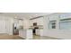 Contemporary kitchen featuring white cabinetry, granite countertops, and stainless steel refrigerator at 4550 Windy Oak Way, St Cloud, FL 34772