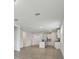 Open-concept kitchen with island, white cabinets, and stainless steel appliances at 4550 Windy Oak Way, St Cloud, FL 34772