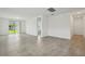 Spacious living room with neutral tile flooring and sliding glass doors leading to backyard at 4550 Windy Oak Way, St Cloud, FL 34772