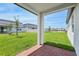 View from the covered patio overlooking a spacious, grassy backyard, ideal for outdoor activities at 4550 Windy Oak Way, St Cloud, FL 34772