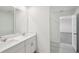 Bathroom with double sink vanity, large mirrors and view to the hallway at 4556 Windy Oak Way, St Cloud, FL 34772