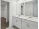Bathroom with double sink vanity, large mirrors and walk-in closet at 4556 Windy Oak Way, St Cloud, FL 34772
