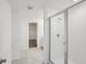Modern bathroom with glass shower, white tile, and neutral colored floor at 4556 Windy Oak Way, St Cloud, FL 34772