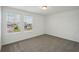 Bedroom featuring neutral carpeting, white walls, and windows providing natural light at 4556 Windy Oak Way, St Cloud, FL 34772
