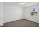This bedroom features neutral carpeting, white walls, and a window at 4556 Windy Oak Way, St Cloud, FL 34772