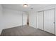 Bedroom featuring neutral carpeting, white walls and closet space at 4556 Windy Oak Way, St Cloud, FL 34772