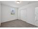 This bedroom features neutral carpeting, white walls, a closet, and a window at 4556 Windy Oak Way, St Cloud, FL 34772