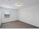 Bedroom featuring neutral carpeting, white walls, and window providing natural light at 4556 Windy Oak Way, St Cloud, FL 34772