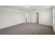 Neutral bedroom featuring neutral carpeting, white walls and open doorway at 4556 Windy Oak Way, St Cloud, FL 34772
