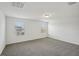 Bedroom featuring neutral carpeting, white walls, and windows providing natural light at 4556 Windy Oak Way, St Cloud, FL 34772