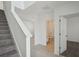 Bright entryway showcasing staircase and open view to bathroom and living space at 4556 Windy Oak Way, St Cloud, FL 34772