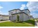 Charming two-story home featuring a two-car garage, complemented by a lush green lawn at 4556 Windy Oak Way, St Cloud, FL 34772