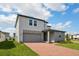 Beautiful two-story house featuring a brick driveway, two-car garage, and a well-maintained lawn at 4556 Windy Oak Way, St Cloud, FL 34772