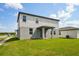 Rear exterior of home featuring a walkout covered porch and well-manicured lawn at 4556 Windy Oak Way, St Cloud, FL 34772