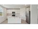 Bright kitchen features stainless steel appliances, a center island, and white cabinets at 4556 Windy Oak Way, St Cloud, FL 34772