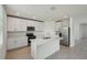 Bright kitchen features stainless steel appliances, a center island, and white cabinets at 4556 Windy Oak Way, St Cloud, FL 34772