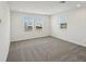 This living room features neutral carpeting, white walls, and several windows at 4556 Windy Oak Way, St Cloud, FL 34772
